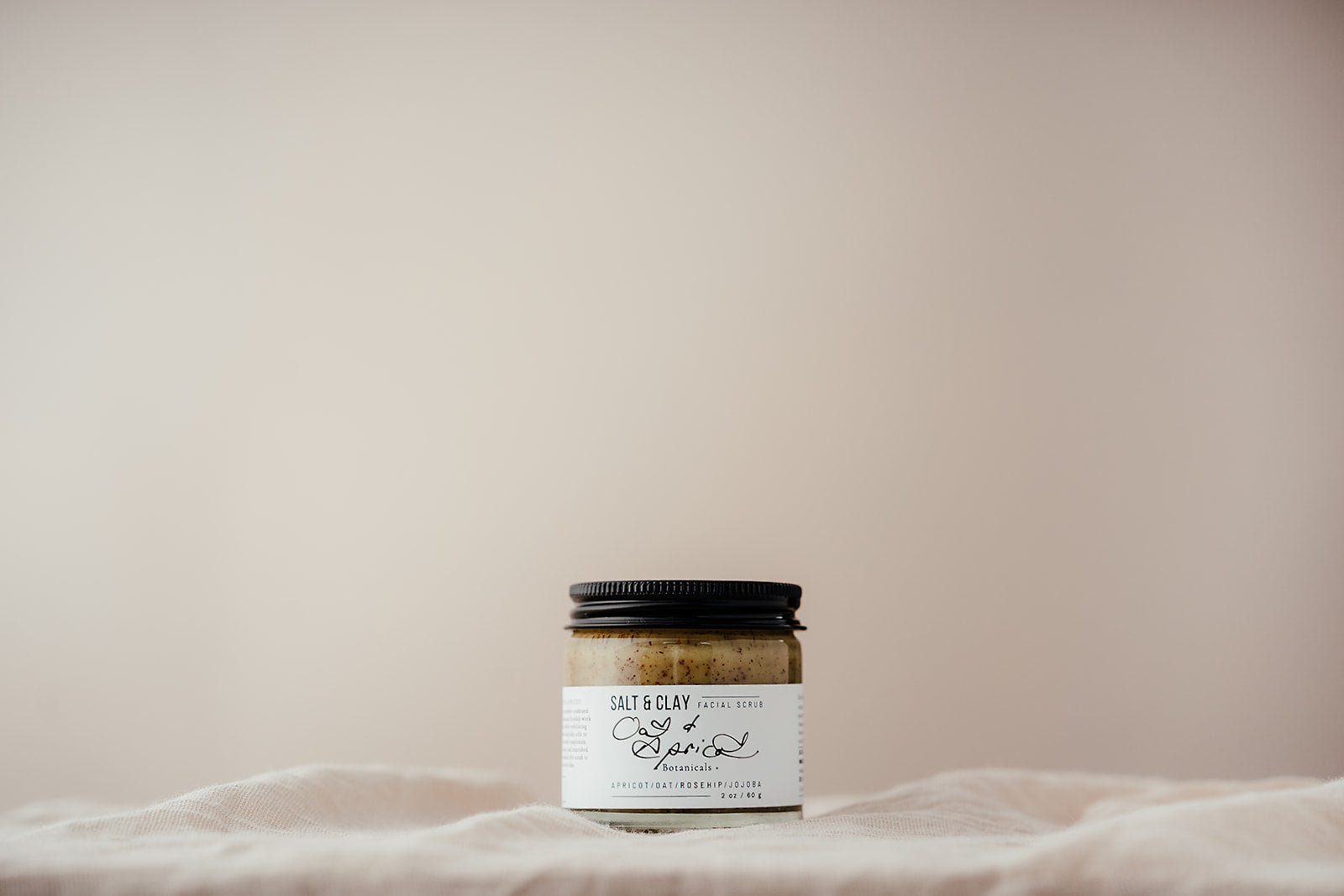 Oat and Apricot face scrub made by Salt and Clay. Packaged in a recycled glass jar with a recyclable aluminium lid. Vegan friendly skincare.  