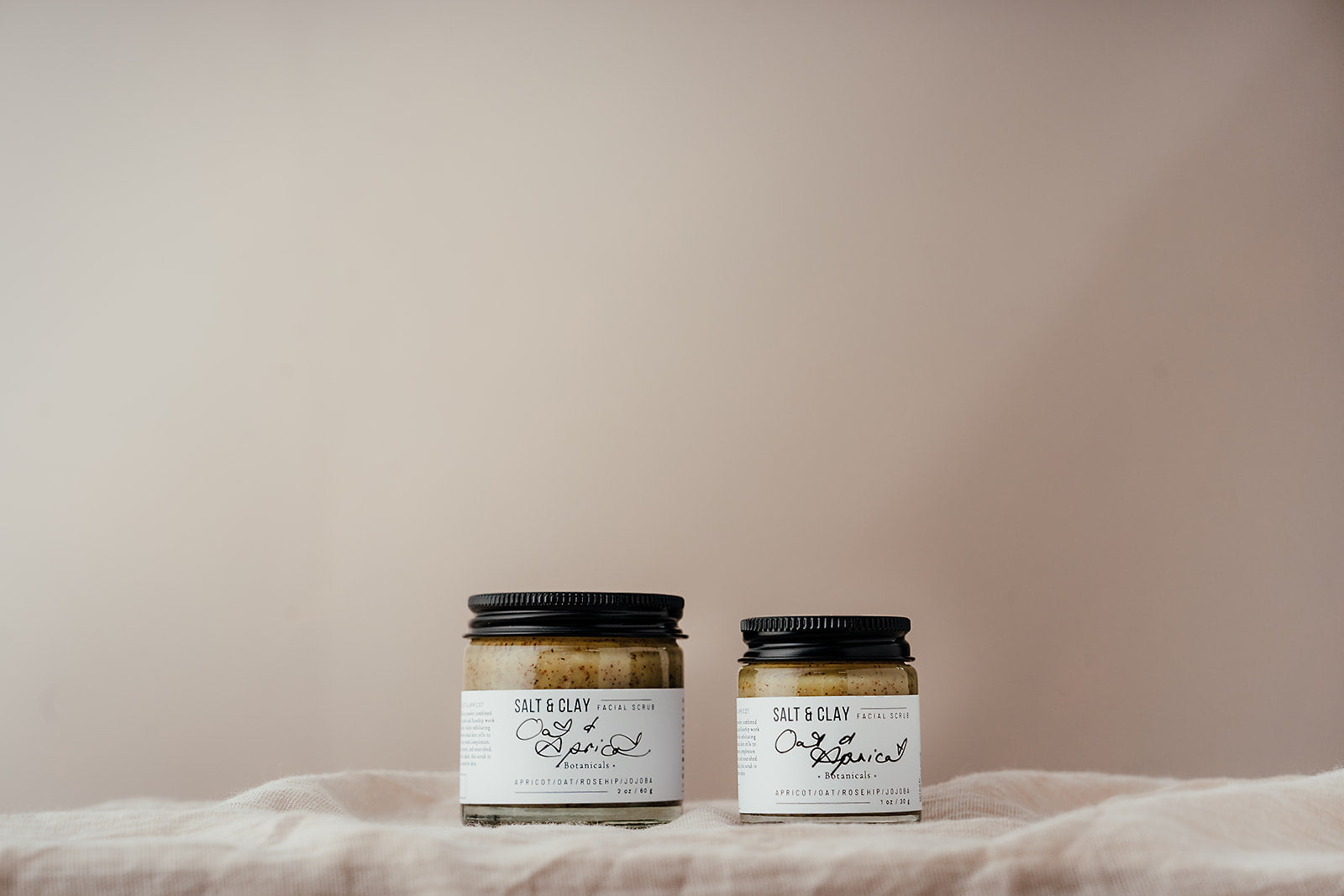 Oat and Apricot face scrub made by Salt and Clay. Packaged in a recycled glass jar with a recyclable aluminium lid. Vegan friendly skincare.  